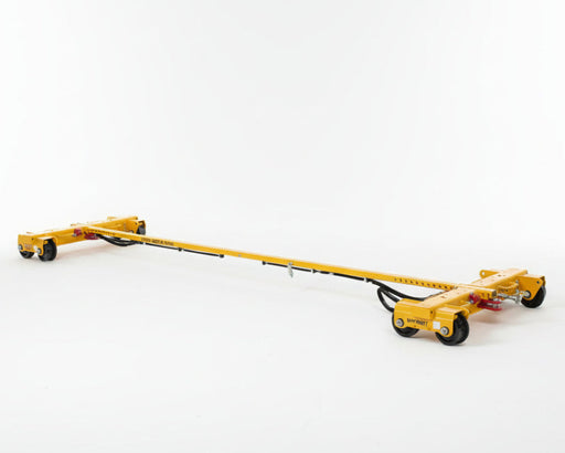 Yellow Rail and girder trolley on a concrete surface with other similar equipment in the background.