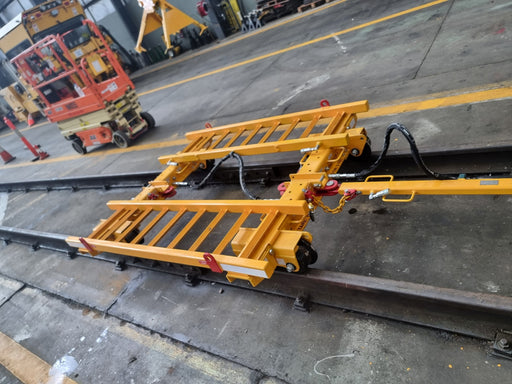 yellow rail trolley in a workshop on rail.